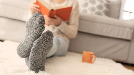Person reading a book with cosy socks on